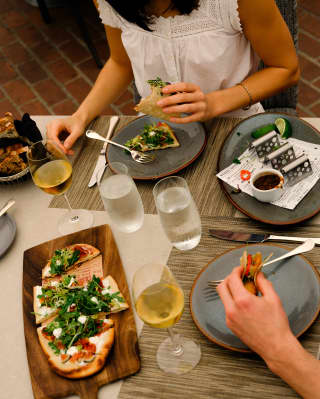 View over lunch at the Dining Room as guests enjoy white wine, tacos and flatbread with figs, prosciutto and goat cheese.